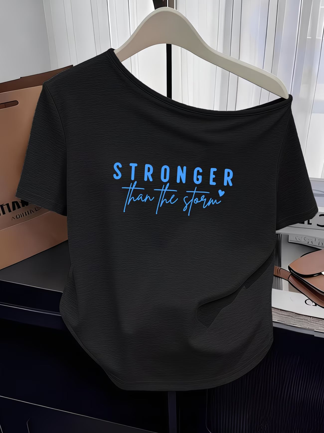 Women's Y2K Off-Shoulder Tee – "Stronger Than The Storm" Slogan Print