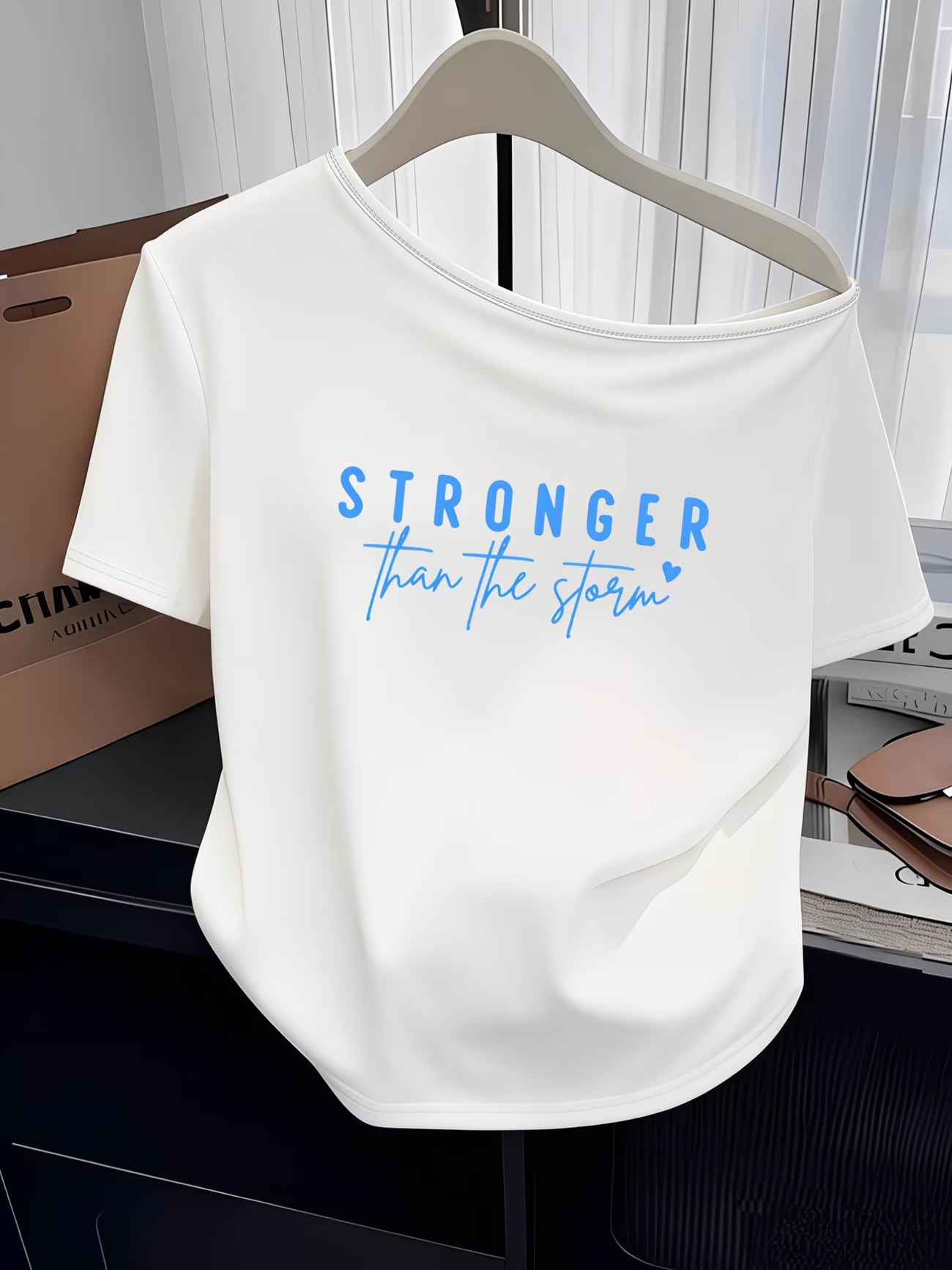 Women's Y2K Off-Shoulder Tee – "Stronger Than The Storm" Slogan Print