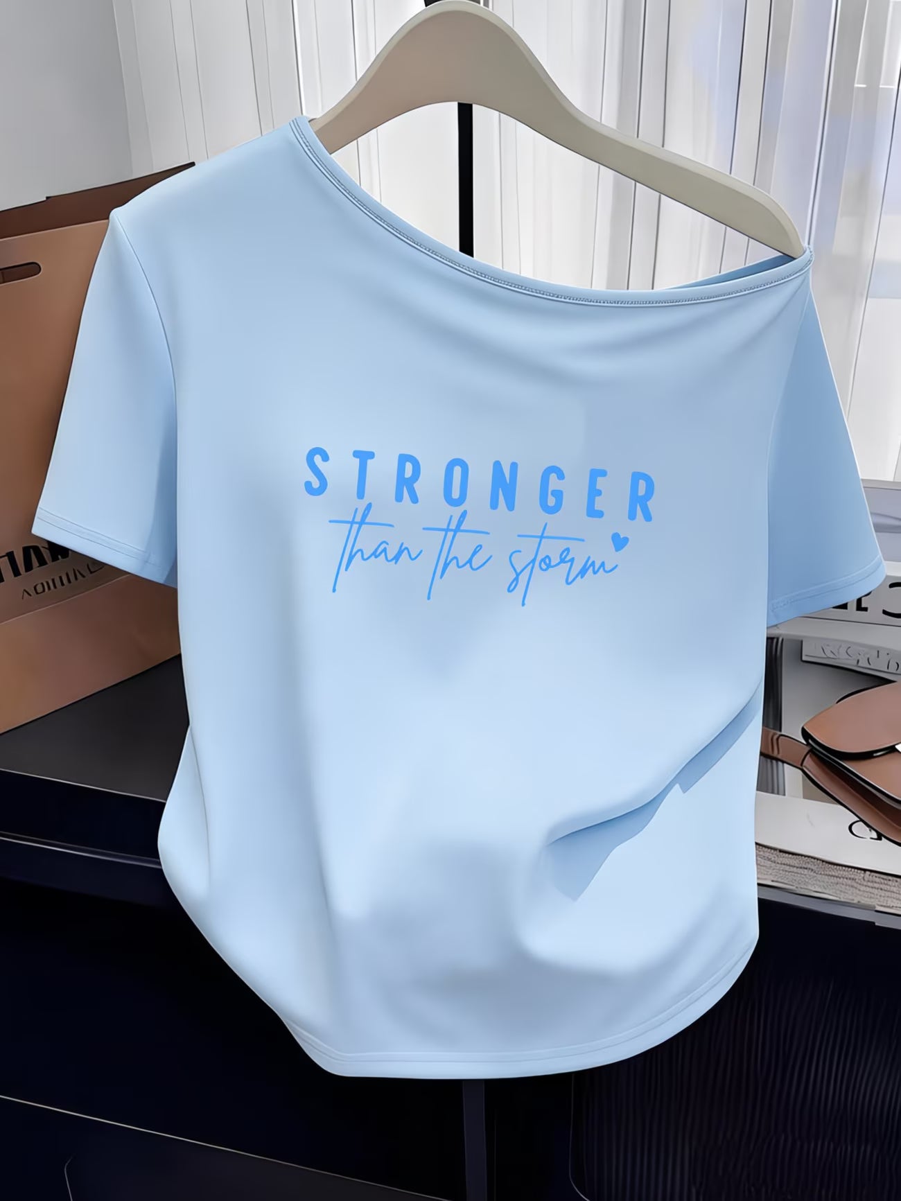 Women's Y2K Off-Shoulder Tee – "Stronger Than The Storm" Slogan Print