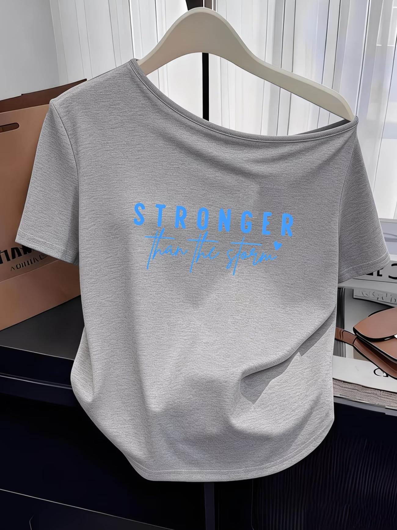 Women's Y2K Off-Shoulder Tee – "Stronger Than The Storm" Slogan Print